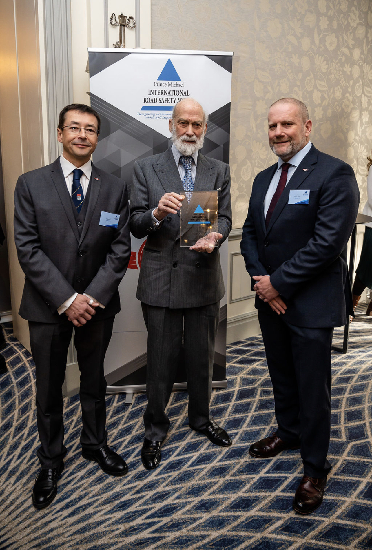 DocBike Co-Founders and Trustees Dr Ian Mew & Chris Smith QPM, being presented with the award by HRH Prince Michael of Kent DocBike Co-Founders and Trustees Dr Ian Mew & Chris Smith QPM, being presented with the award by HRH Prince Michael of Kent